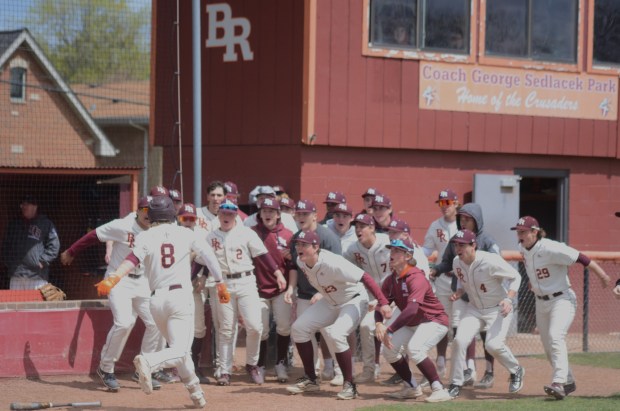 Brother Rice's Nolan Ramoley (8) gets greeted by his teammates after hitting a home run in the fifth inning of a Catholic League Blue game at Brother Rice in Chicago on Saturday April 20, 2024. (Jeff Vorva / Daily Southtown)