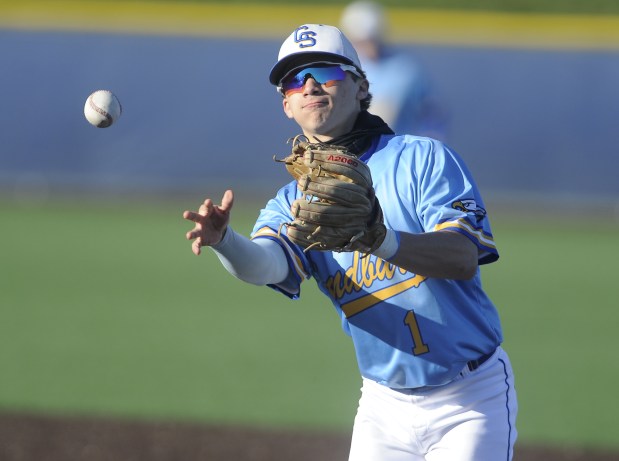 Sandburg's Michael Stapleton (1) makes the flip to first base against Thornwood during a nonconference game Friday, April 5, 2024 in Orland Park, IL. (Steve Johnston/Daily Southtown)