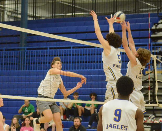 Oak Lawn's Simon Komperda, left, tries to hit through Sandburg's block during a nonconference match in Orland Park on Wednesday, April 17, 2024. (Jeff Vorva / Daily Southtown)