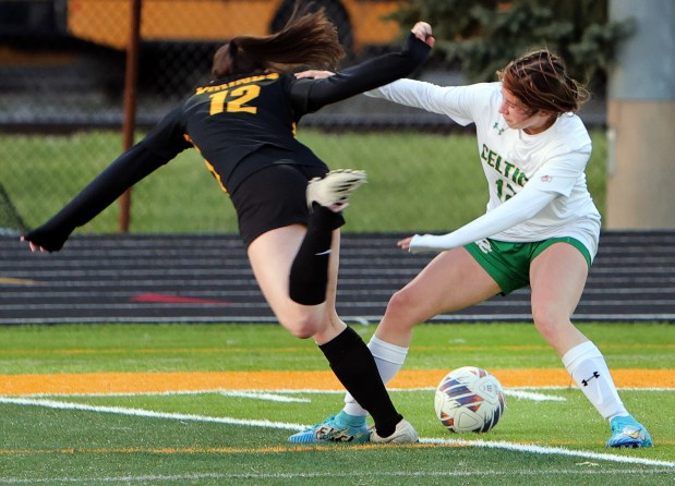 St. Laurence's Kathleen Martin and Providence's Maggie Wolniakowski battle for the ball during the soccer game in Burbank Monday, April 8, 2024. (James C. Svehla/for the Daily Southtown)