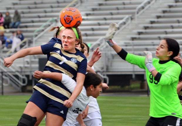 Lemont's Chase Bergeson heads the ball near Reavis goal during the soccer game in Lemont Thursday, April 18, 2024. (James C. Svehla/for the Daily Southtown)