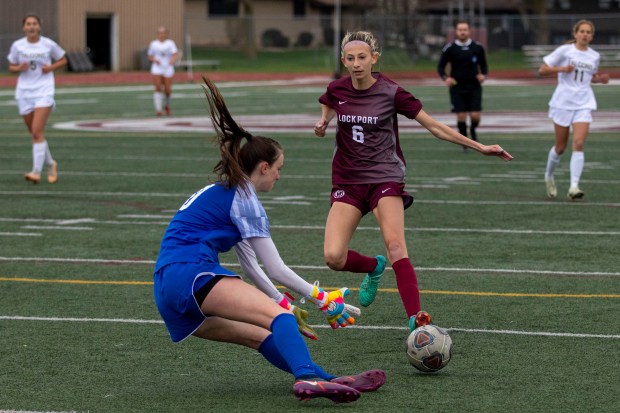 Lockport's Ava Kozak (6) approaches Wheaton North's goalkeeper Leah Roe (0) during the Lockport Invitational Championship in Lockport on Thursday, April 11, 2024. (Nate Swanson/for the Daily Southtown)