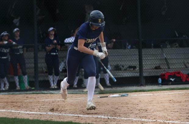 Lemont's Allison Pawlowicz (25) runs to first base after making contact with the ball during a game against Minooka in Lemont on Wednesday, April 10, 2024. (Troy Stolt/for the Daily Southtown)