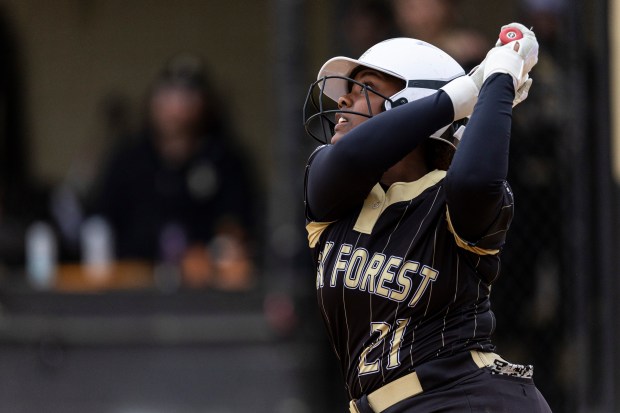 Oak Forest's Imani Hogan looks up after connecting with a pitch against Richards during a South Suburban Conference crossover in Oak Forest on Wednesday, April 17, 2024. (Vincent D. Johnson/for the Daily Southtown)