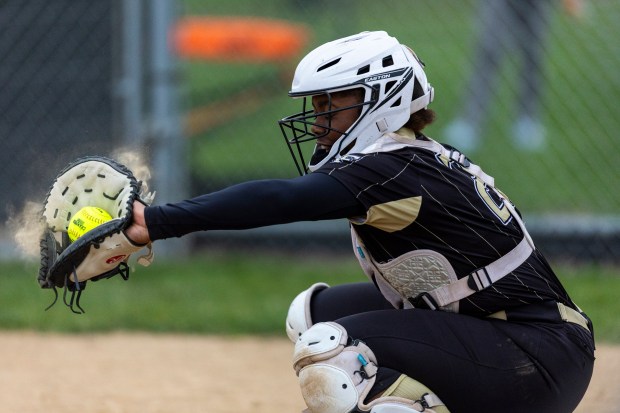 Oak Forest's Imani Hogan catches a strike from Oak Forest's Melanie Andrysiak during a South Suburban Conference crossover game against Richards in Oak Forest on Wednesday, April 17, 2024. (Vincent D. Johnson/for the Daily Southtown)