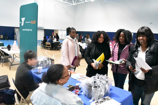 A group of students learns more about the Y Saturday at a Hillcrest High School job and volunteer opportunity event. (Jesse Wright/for Daily Southtown)