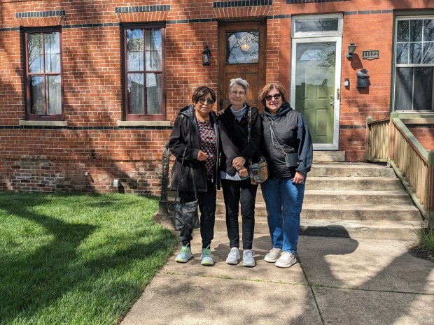 Childhood friends, from left, Beverly Bravo, Anita Ferguson and Denise Fattori-Alcantar, who grew up in Pullman, stand outside the outside the Americo Lisciotto home after a tour last weekend in Chicago's Pullman neighborhood. (Janice Neumann/Daily Southtown)