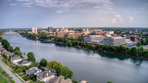 The skyline of downtown Augusta reflects in the Savannah River, the dividing line with North Augusta, South Carolina.  Augusta was founded in 1736 and named for Princess Augusta of Saxe-Gotha-Altenburg, wife of Frederick, Prince of Wales. (Destination Augusta)