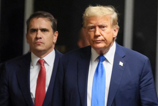 Republican presidential candidate and former U.S. President Donald Trump walks next to his attorney Todd Blanche, at Manhattan state court in New York, Monday, April 22, 2024. (Brendan McDermid/Pool Photo via AP)