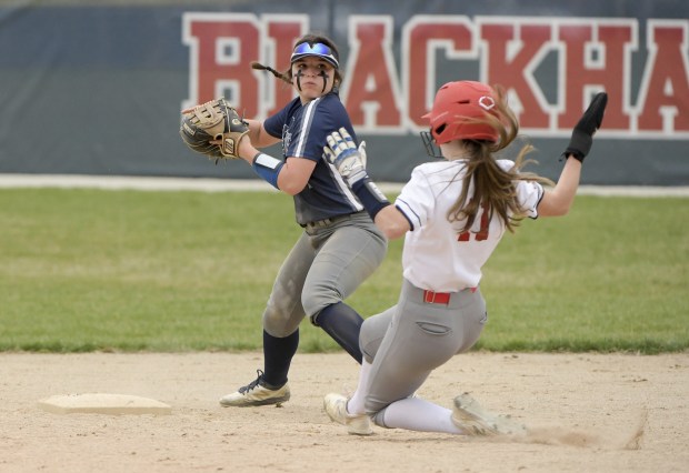 Oswego East's Gracie Vlach, left, looks to first base after forcing West Aurora's Keira Hayton (11) at second base during a Southwest Prairie Conference game on Tuesday, April 12, 2022.