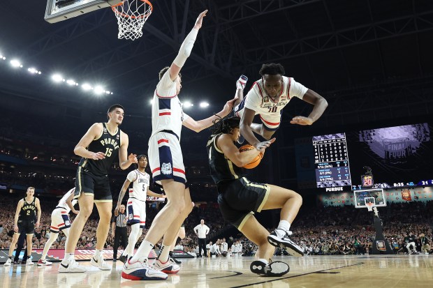 Hassan Diarra #10 of the Connecticut Huskies flips over Trey Kaufman-Renn #4 of the Purdue Boilermakers in the first half during the NCAA Men's Basketball Tournament National Championship game at State Farm Stadium on April 8, 2024 in Glendale, Arizona. (Christian Petersen/Getty)
