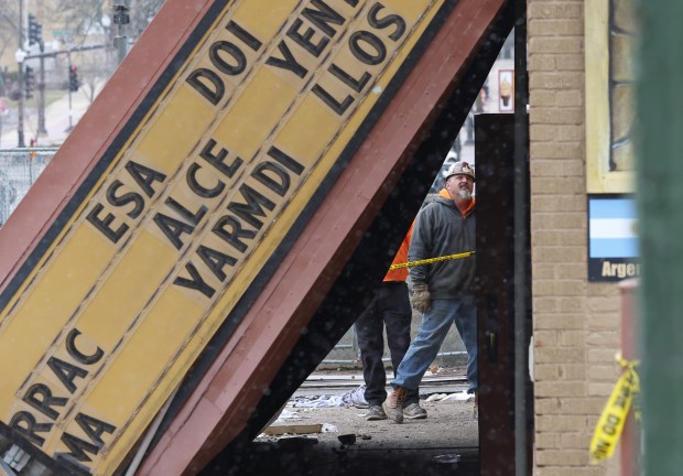 Heavy equipment operators survey the exterior damage of the Apollo Theatre on April 1, 2023, in Belvidere. Tornado-strength winds on March 31 collapsed the venue's roof and marquee sign during a concert, injuring at least 28 people and one fatally. (John J. Kim/Chicago Tribune)