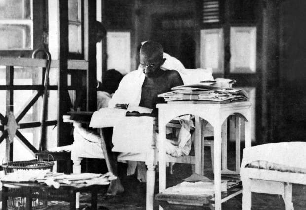 Indian statesman Mahatma Gandhi reads his correspondence while living in seclusion after being released from prison, circa May 1924. (Topical Press Agency/Getty Images)