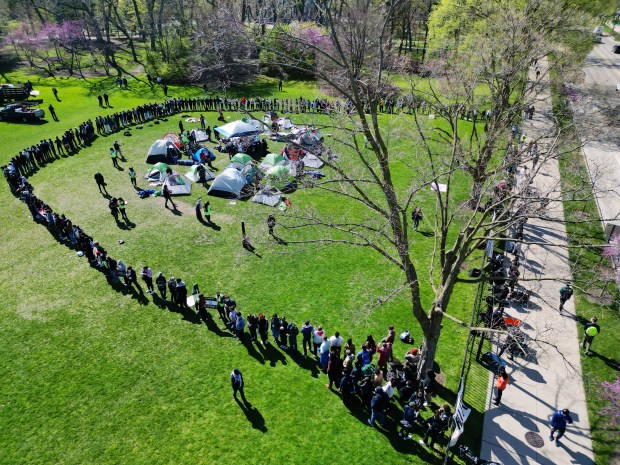 Northwestern University students and community members form an encampment on campus in Deering Meadow on April 25, 2024, in Evanston. They say they will occupy the area until Northwestern stops supporting Israel's actions in Gaza and meets several student demands. (Stacey Wescott/Chicago Tribune)