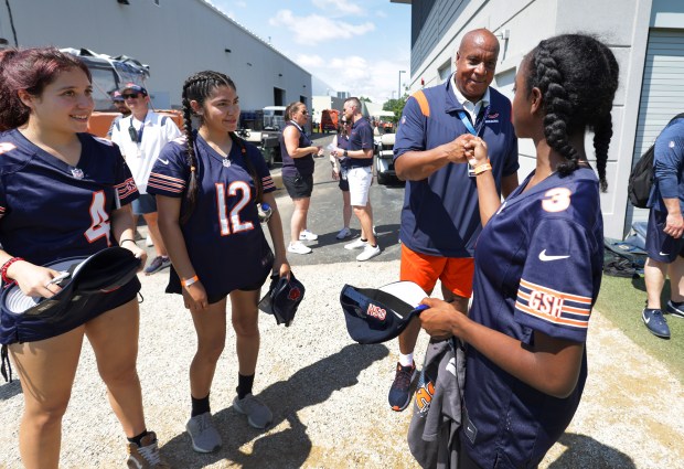 New Chicago Bears president and CEO, Kevin Warren, fist bumps with flag football players, left to right: Emma Jazmin Valenzuela (Cicero), Karla Rodriguez Martinez (Gage Park), and Saniya Shotwell (Oak Park) during the Chicago Bears training camp on Saturday, July 29, 2023, in Lake Forest. (Stacey Wescott/Chicago Tribune)
