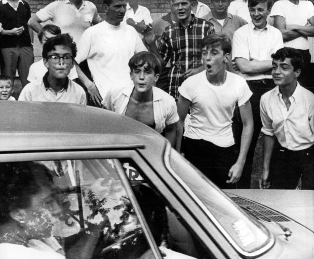 Hecklers jeer at civil rights demonstrators during a march on July 14, 1966, to protest against housing discrimination in Gage Park and other areas of Chicago. Several were arrested, several were injured and cars were damaged. (Chicago Tribune historical photo)