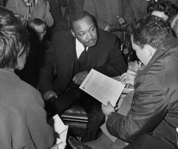 Civil Rights Leader Rev. Martin Luther King Jr. discusses fair housing with Gilbert Balin, of G. Balin Inc. real estate agents, at his real estate office on Nov. 3, 1966. (Jack Mulcahy/Chicago Tribune)