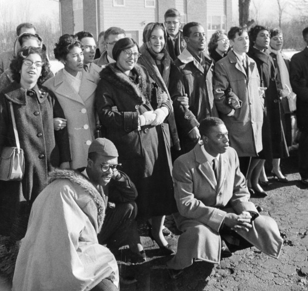Members of the Chicago Youth Committee on Civil Rights hold a demonstration at the site of a proposed integrated housing project in Deerfield on Christmas Day, 1960. The group held 'kneel-ins' at five area churches earlier that day. (Associated Press)