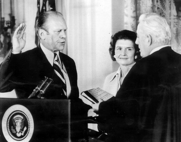 Gerald Ford takes the oath of office as the 38th President of the United States on Aug. 9, 1974, after Richard Nixon's resignation. Betty Ford looks on as Chief Justice Warren Burger administers the oath. (AP photo)
