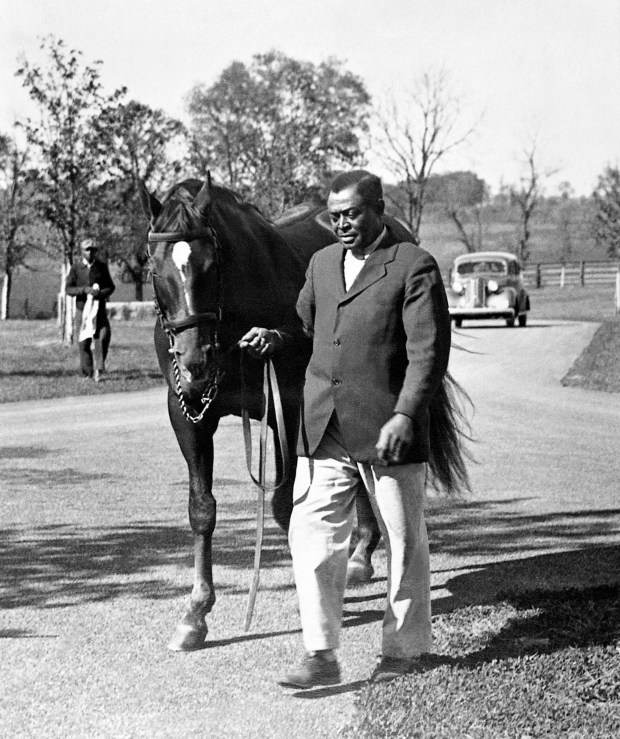 Will Harbut walks Man o' War in 1937. (Keeneland Library Meadors Collection)