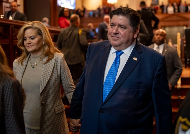 Gov. J.B. Pritzker departs with first lady M.K. Pritzker after delivering his State of the State and budget address, Feb. 21, 2024. (Brian Cassella/Chicago Tribune)