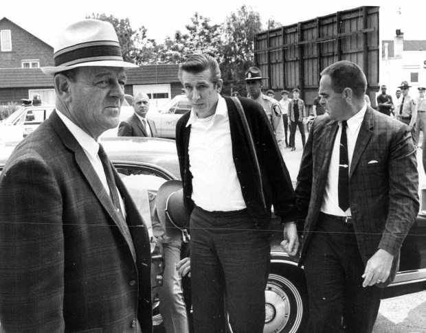 Richard Speck, center, is brought to the Joliet prison Diagnostic Center for processing after being given the death sentence at his trial in Peoria on June 5, 1967. Sheriff Willard Koeppel, of Peoria, left, and undersheriff Richard Diekhoff, right, escort Speck, who will then be transferred to Stateville prison. (William Yates/Chicago Tribune)