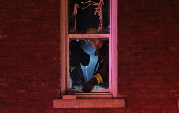 Firefighters work to extinguish an extra-alarm fire that damaged at least three structures, completely destroying one building, in the 1300 block of West 16th Street Wednesday, April 17, 2024, in Chicago. (John J. Kim/Chicago Tribune)