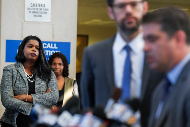 Cook County State's Attorney Kim Foxx, left, listens as attorney Joshua Tepfer speaks regarding the move to vacate and dismiss drug charges against 18 men at the Leighton Criminal Court Building in Chicago on Sept. 24, 2018. (Jose M. Osorio/Chicago Tribune)