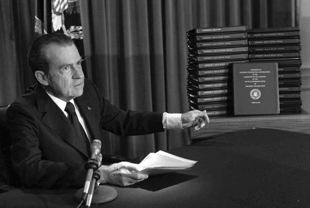 President Richard M. Nixon points to the transcripts of the White House tapes after he announced during a nationally-televised speech on April 29, 1974, that he would turn over the transcripts to House impeachment investigators. (AP Photo)