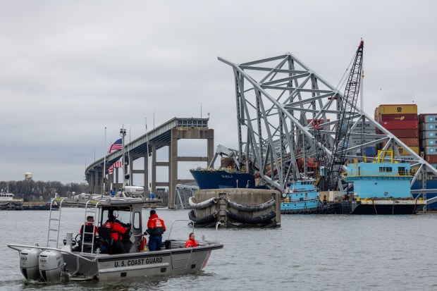 Wreckage from the collapsed Francis Scott Key Bridge rests on the cargo ship Dali efforts begin to clear the debris and reopen the Port of Baltimore on April 1, 2024 in Baltimore, Maryland. Two survivors were pulled from the Patapsco River and six missing people are presumed dead after the Coast Guard called off rescue efforts. A work crew was fixing potholes on the bridge, which is used by roughly 30,000 people each day, when the ship struck. The accident has temporarily closed the Port of Baltimore, one of the largest and busiest on the East Coast of the U.S. (Tasos Katopodis/Getty)