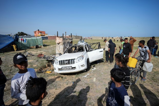 People inspect the site where World Central Kitchen workers were killed in Deir al-Balah, Gaza Strip on Tuesday, April 2, 2024. World Central Kitchen, an aid group, says an Israeli strike that hit its workers in Gaza killed at least seven people, including several foreigners. (Abdel Kareem Hana/AP)