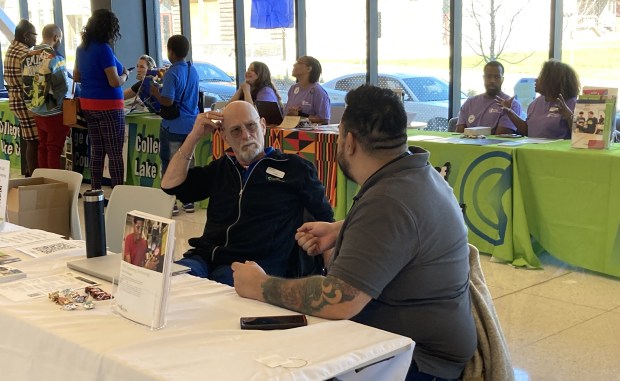 Two people staff a table at the College of Lake County's open house Saturday at the Lakeshore Campus in Waukegan. (Steve Sadin/Lake County News-Sun)