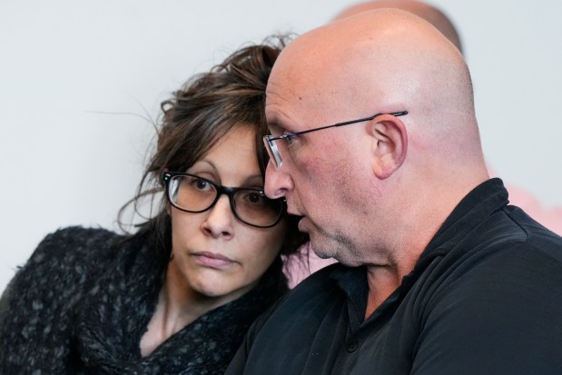 Robert E. Crimo III's mother Denise Pesina, left, listens to Robert E. Crimo III's father Robert Crimo Jr., as they attend for a case management meeting for Robert E. Crimo III., in Lake County court before Judge Victoria A. Rossetti Wednesday, April 24, 2024, in Waukegan, Ill. Crimo III is charged with killing seven people and wounding dozens more in a shooting at an Independence Day parade in the suburban Chicago town of Highland Park, Ill. (AP Photo/Nam Y. Huh, Pool)