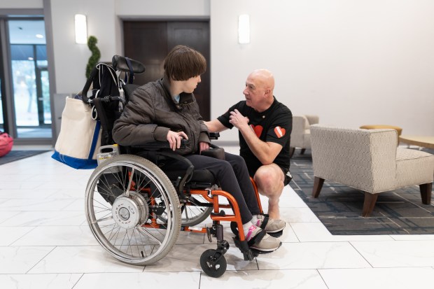 Jim Elliott speaks with Erin Tunison before her scuba diving class in Downers Grove on Monday, April 1, 2024. (Troy Stolt/for the Lake County News Sun)