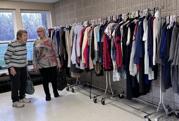 Grayslake residents Kathleen Kinahan, left, and Alison Domecq tour the part of the Avon Township Center where donated clothes and shoes are displayed during an event on April 8. (Yadira Sanchez Olson/Lake County News-Sun)