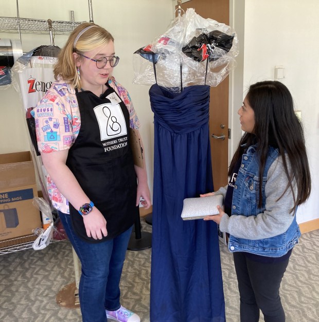 Ashly Roman, right, and her personal shopper, Susan Brooks, talk about the prom dress and purse she selected. (Steve Sadin/Lake County News-Sun)