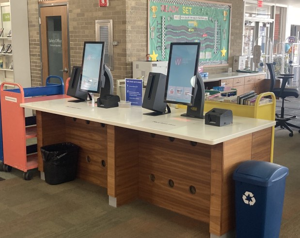 Once a manual process, patrons can now check books out of the library on a computer. (Steve Sadin/Lake County News-Sun)