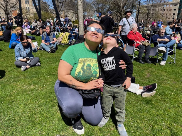 Destiny Star and her son Lincoln Star, of Ravenswood, posing for a picture as they safely view the partial eclipse. Credit: Richard Requena