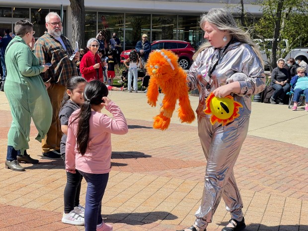 Children's Librarian Mandy O'Brien with her puppet Schmoranges at the Skokie Public Library viewing of the partial eclipse on April 8, 2024. Credit: Richard Requena