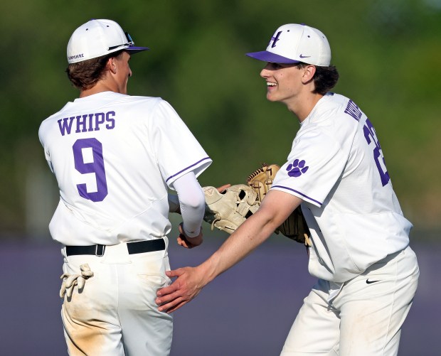 Hampshire's Jack Perrone (9) and Anthony Karbowski (22) slap gloves as they congratulate each other for the second out in the sixth inning during a Fox Valley Conference game against Burlington Central on Friday, May 3, 2024 in Hampshire. Hampshire won, 7-3.H. Rick Bamman / For the Beacon-News
