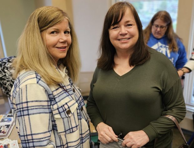Friends Eileen Gutierrez of Geneva, left, and Susan Kraus of Streamwood said they each retired recently and were looking for volunteer opportunities Thursday at the Batavia Chamber of of Commerce Volunteer Fair at the Batavia Public Library. (David Sharos / For The Beacon-News)