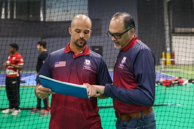 Breybourne Cricket Club Chairman and CEO Paresh Patel, right, goes over notes with Coach JP Duminy during tryouts for the Breybourne Cricket Club in Naperville on Wednesday, March 27, 2024. (Troy Stolt/for the Aurora Beacon News)