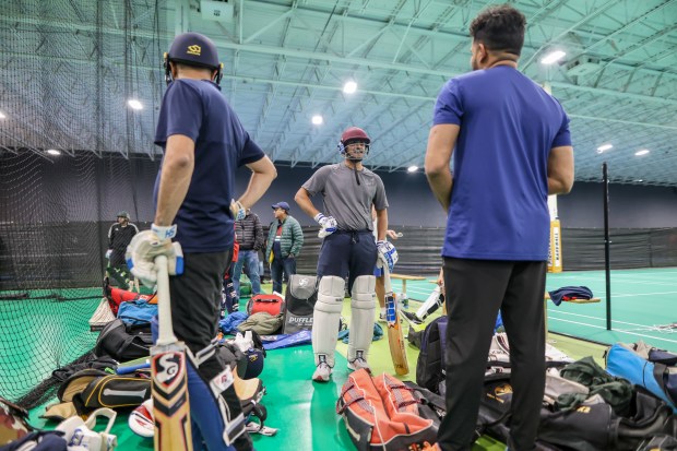 Dev Patel, center, speaks with other cricketers during tryouts for the Breybourne Cricket Club in Naperville on Wednesday, March 27, 2024. (Troy Stolt/for the Aurora Beacon News)