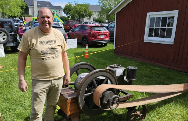 Joe Richmond of Sandwich shows off a generator used on farms around the turn of the 20th century during the Spring at the Dickson-Murst Farm event in Montgomery on Sunday. (David Sharos / For The Beacon-News)