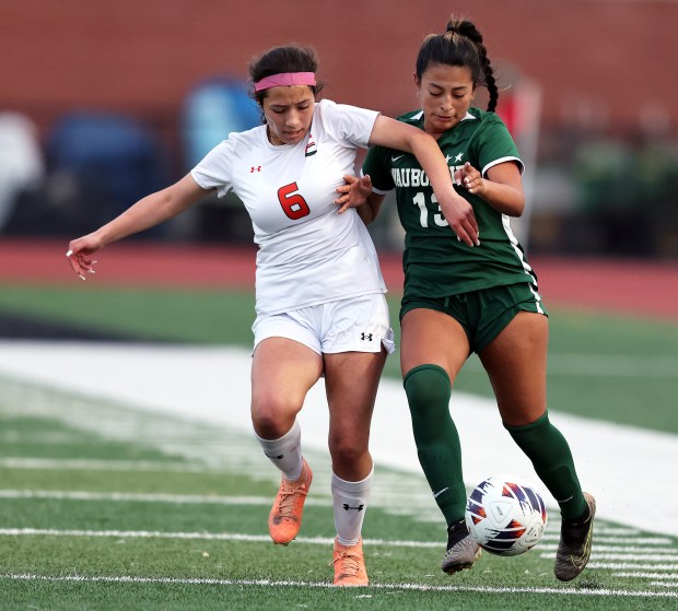 Waubonsie Valley's Thanya Castelan (13) battles Plainfield East's Isabelle Bustamante-Lopez (6) for control in the second half during the Class 3A East Aurora Regional semifinal game on Tuesday, May 14, 2024 in Aurora. Waubonsie Valley won, 4-0.H. Rick Bamman / For the Beacon-News