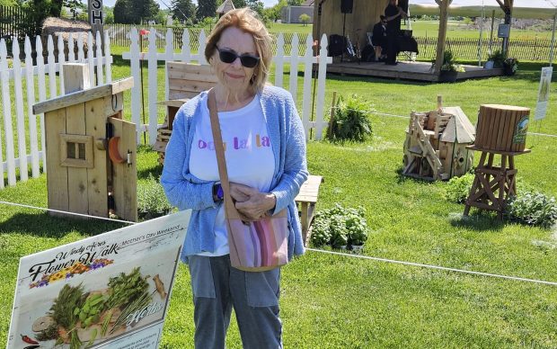 Batavia resident Michelle Pfister checks out a flower-scape focusing on herbs Saturday during the Mother's Day Flower Walk at Windy Acres Farm near Geneva. The event is set to end on Sunday. (David Sharos / For The Beacon-News)