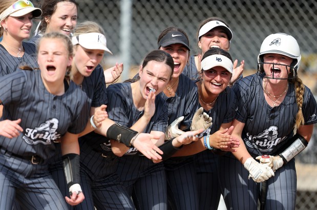Kaneland players cheer at home plate after Isabelle Stombres' first inning home run during a Class 2A Kaneland Regional Softball semifinal game against Crystal Lake Central on Tuesday, May 21, 2024 in Maple Park. Kaneland advanced with the 3-0 win. H. Rick Bamman / For the Beacon-News