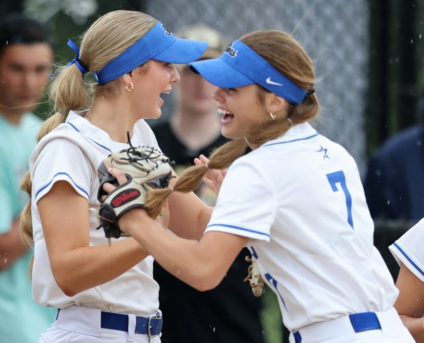 St. Charles North teammates Haley Nelson, left, and Mackenzie Patterson (7) greet each other before a rain postponed DuKane Conference game Monday, April 13, 2024 in St. Charles.H. Rick Bamman / For the Beacon-News