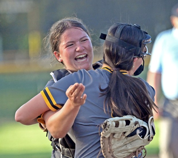 Metea Valley's Elena Gonzales hugs Charlie Benesh after the final out. Metea Valley defeated Naperville Central, 6-4 in softball, Friday, May 10, 2024, in Aurora, Illinois. (Jon Langham/for the Beacon-News)