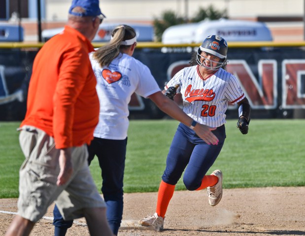 Oswego's Jaelynn Anthony is greeted by her coaches as she rounds third base with a home run against Wheaton Warrenville South during a Class 4A Plainfield North Sectional semifinal game on Wednesday, May 29, 2024, in Plainfield.(Jon Cunningham/for The Beacon-News)